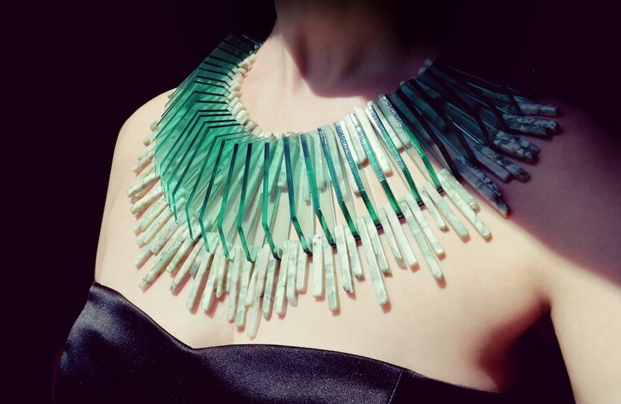 A geometric teal plastic necklace on a woman