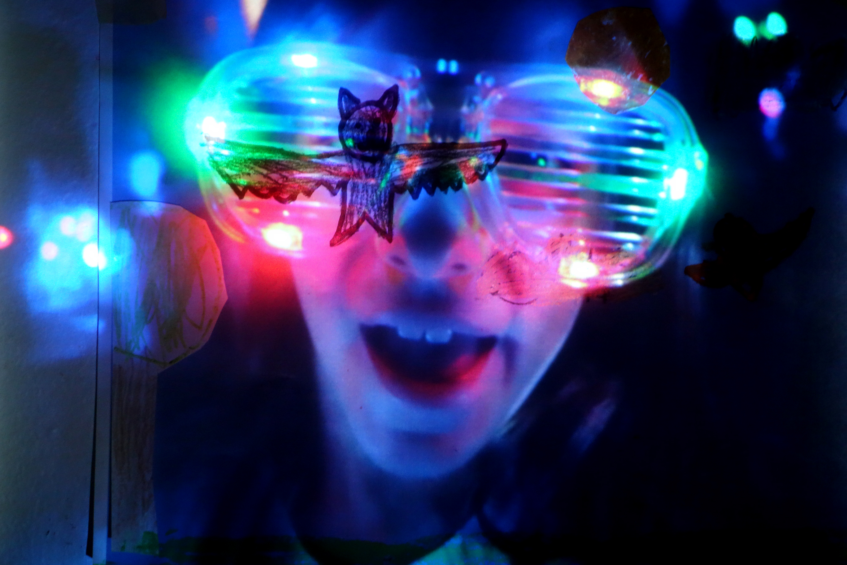 A child wearing light-up plastic glasses