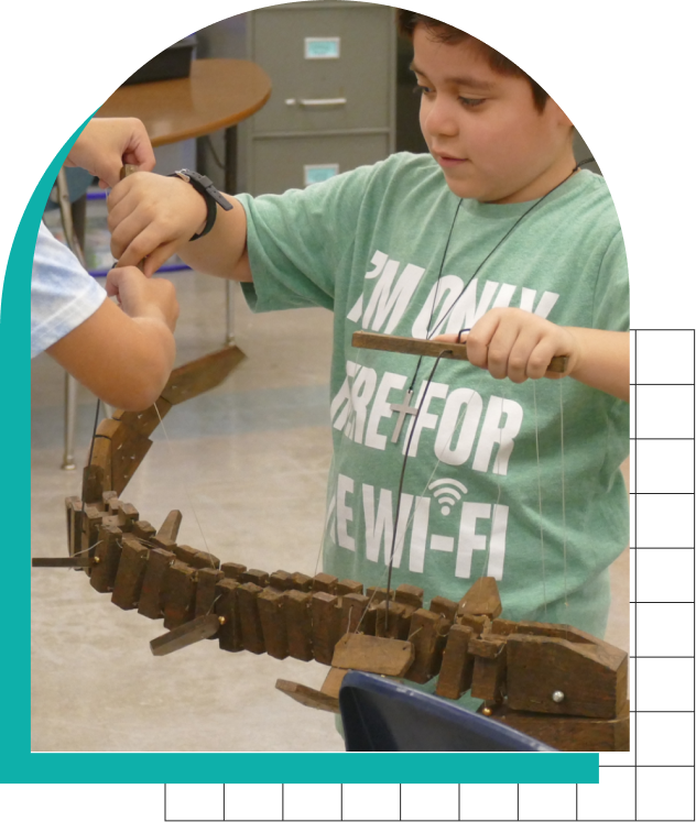 Student from AIR program playing with wooden sea animal creation