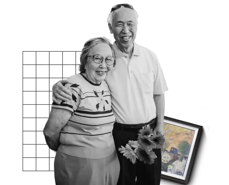 An older couple with a man holding flowers and hugging his wife