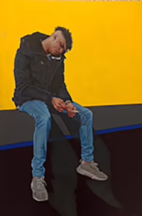 A person in a black jacket, blue jeans, and gray shoes sits on a ledge against a bright yellow background, looking down with hands clasped and casting a shadow on the dark ground.
